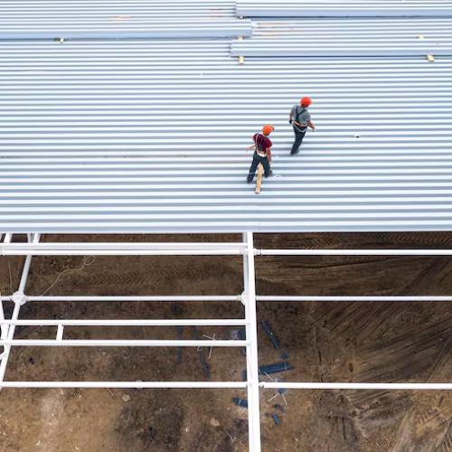 workers-install-roof-modern-frame-building-top-view-from-drone_151992-1962